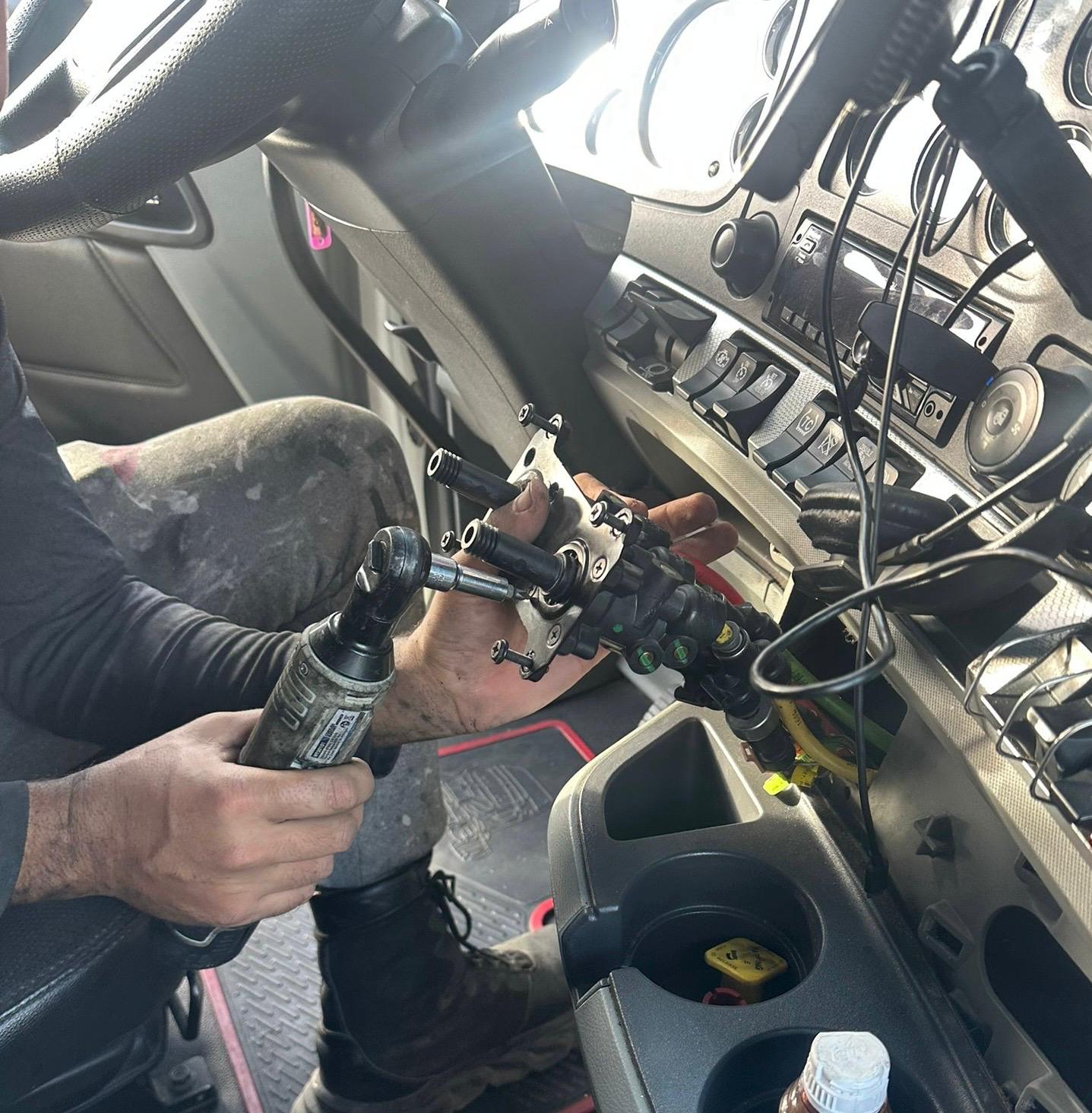 Truck mechanic inspecting commercial vehicle Austin TX